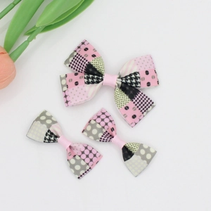 Detailed view of three-piece grosgrain bow clips featuring mixed polka dots and houndstooth