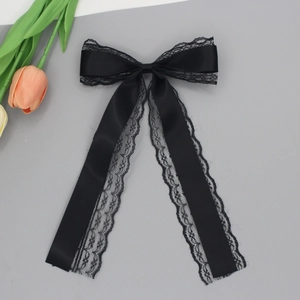 Vue détaillée du nœud en satin noir et dentelle avec de longs rubans élégants pour cheveux