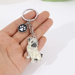 Detailed view of pug metal enamel keychain with paw charm and silver metal keyring