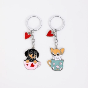 Detail of cartoon dachshund and chihuahua dog charms in colorful cups with heart pendants