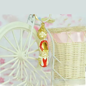 Detail of metal soccer cleat keychain with rhinestone accents and mini football charm