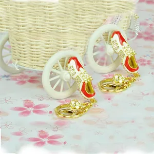 Detailed close-up of custom metal football shoe keychain with rhinestones and mini soccer ball
