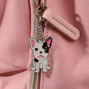Détail d'un sac en toile rose avec un joli pendentif émaillé de bouledogue noir et blanc