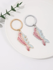 Close-up of colorful gradient fish keychains with crystals and polished metal finish