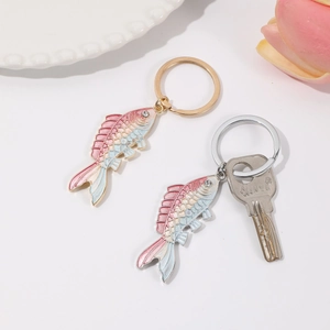 Gradient fish keychain with rhinestones and enamel finish on white floral plate