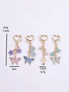 Detail view of colorful butterfly keychains with heart clasps and size measurements