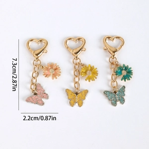 Colorful butterfly and daisy keychain set with heart-shaped lobster clasps and gold chain