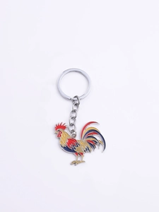 Close-up of vibrant rooster keychain featuring colorful enamel finish and silver metal ring