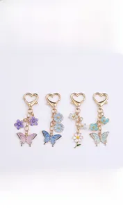 Detailed macro view of four butterfly and flower charms with heart-shaped lobster clasps