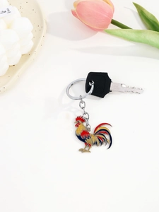 Detailed close-up of a colorful enamel rooster keychain with vibrant floral decorations