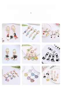 Detail view of various enamel keychain designs including rooster and cute pet dogs