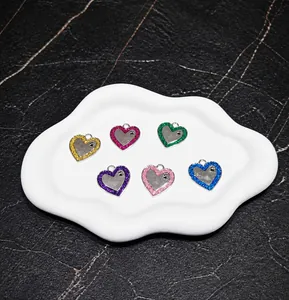 Detail view of heart-shaped pet ID tags in six glittery colors with paw print design