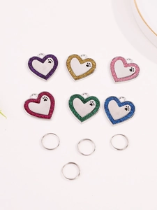 Macro shot of heart-shaped glitter pet ID tags in six colors with paw print details
