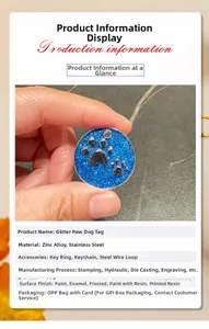 Detailed view of a round blue glitter dog tag with paw print and metal ring attachment