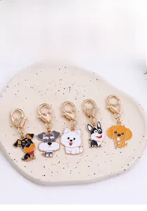 Detailed macro view of assorted cartoon dog charms with golden heart-shaped lobster clasps
