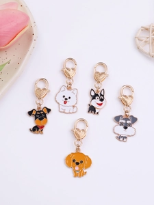 Collection of cartoon dog enamel keychains with golden heart clasps and vibrant colors