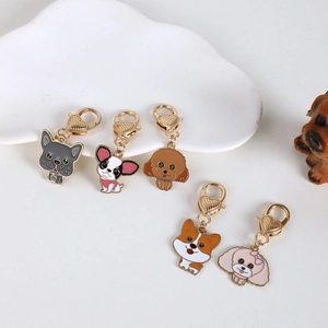 Detail of five cute enamel cartoon dog keychains with gold heart-shaped lobster clasps