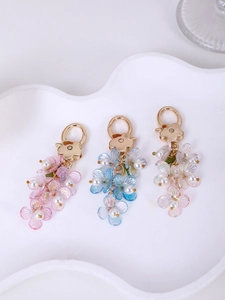 Detail of colorful acrylic flower keychains with lobster clasps and pearl accents