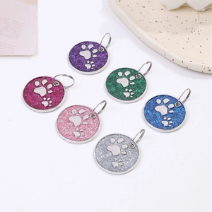 Set of six round glitter metal dog tags with paw prints for pet identification