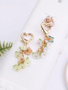Close-up of sweet flower and butterfly charms with heart-shaped lobster clasps