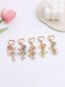 Close-up of colorful resin flower and butterfly keychains with heart lobster clasps
