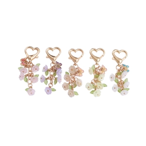 Colorful floral and butterfly keychain set with heart-shaped clasps and pastel petals