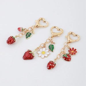 Strawberry pendant keychain with lobster clasp featuring daisy flowers and golden metal chain