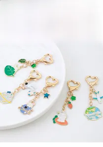 Detail of colorful enamel metal keychains with heart hooks and space rabbit charms