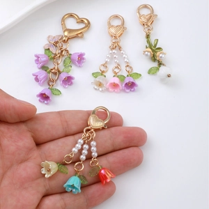 Colorful lily of the valley flower keychain with resin petals and pearl heart charms
