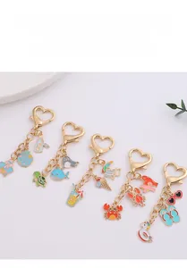 Detail view of summer ocean theme enamel keychains with golden heart carabiner