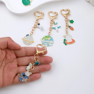 Space rabbit and astronaut enamel keychains with golden heart-shaped lobster clasps