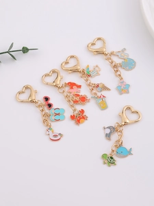Detailed macro view of five colorful enamel summer sea animal keychains with heart clips