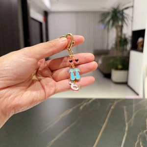 Golden heart keychain with summer beach pendants including sunglasses and flip flops
