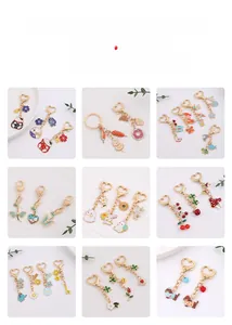 Detailed grid showing colorful enamel metal keychains with cute floral and rabbit motifs
