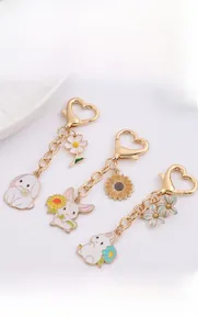 Detail of cartoon rabbit keychains with floral charms and heart shaped gold clasps