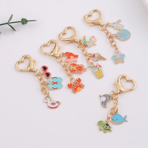 Summer ocean themed keychains with gold heart clasp featuring colorful enamel charms