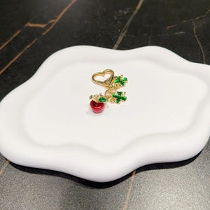 Charming apple and four-leaf clover keychain with a gold heart-shaped lobster clasp