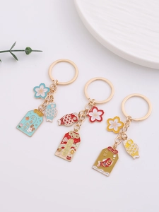 Detailed view of alloy cherry blossom keychains with koi charms and lucky lettering