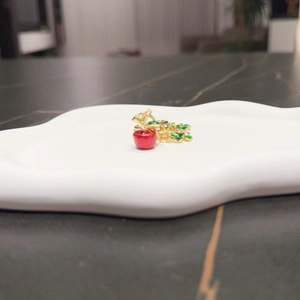 Cute red apple keychain with green leaves and golden lobster clasp on cloud tray