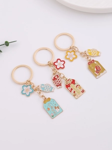Close-up of cherry blossom keychains with koi charms and lucky Chinese characters