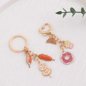 Creative food keychain set with mini dessert cakes and barbecue charms on a white plate