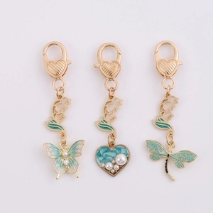 Golden dragonfly and butterfly alloy keychain set with green enamel and pearl accents