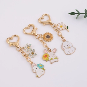 Creative cartoon bunny keychains with flower charms and gold heart-shaped carabiner hooks