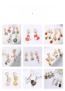 Detail view of custom zinc alloy keychains with cute cartoon cats and floral enamel charms