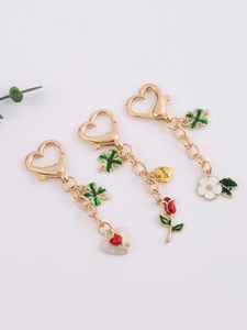 Detailed view of gold alloy heart lobster clasps with rose and clover charms