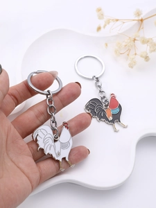 Detailed close-up of colorful oil-painted rooster metal keychains with textured feathers