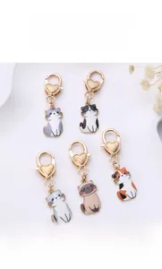 Close-up of five cute zinc alloy cat keychains with heart-shaped golden lobster clasps