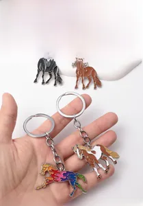Detailed view of horse keychains in black, brown, and rainbow enamel for bag charms