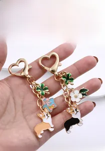 Detail of metal Corgi keychains with gold heart clasps and colorful enamel charms