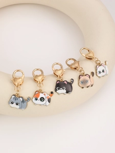 Close-up of five cute enamel cat keychains with golden heart lobster clasps
